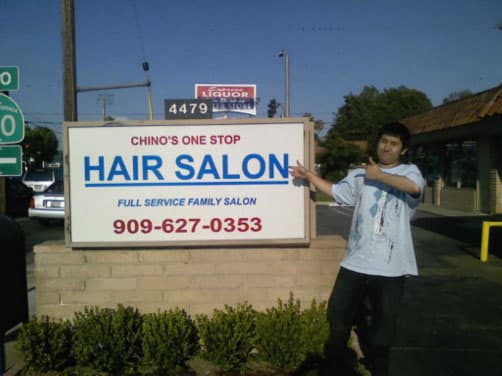 The storefront sign for Chino's One Stop Hair Salon on Riverside Drive